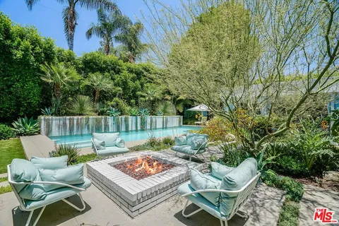 a view of a backyard with plants and patio