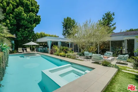 a view of a patio with swimming pool table and chairs