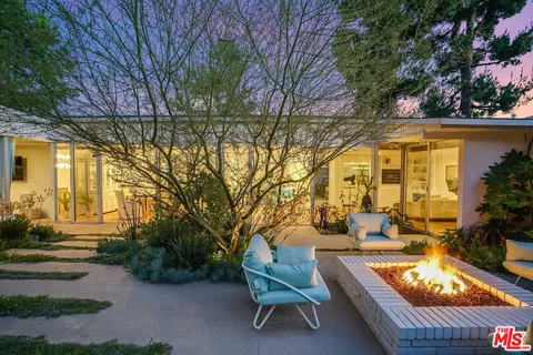 an aerial view of a house with a yard outdoor seating