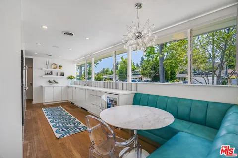 a kitchen with granite countertop a sink and a stove