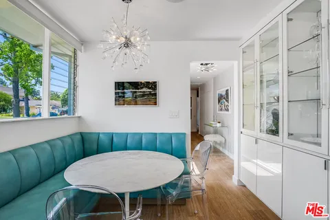 a large white kitchen with a large window