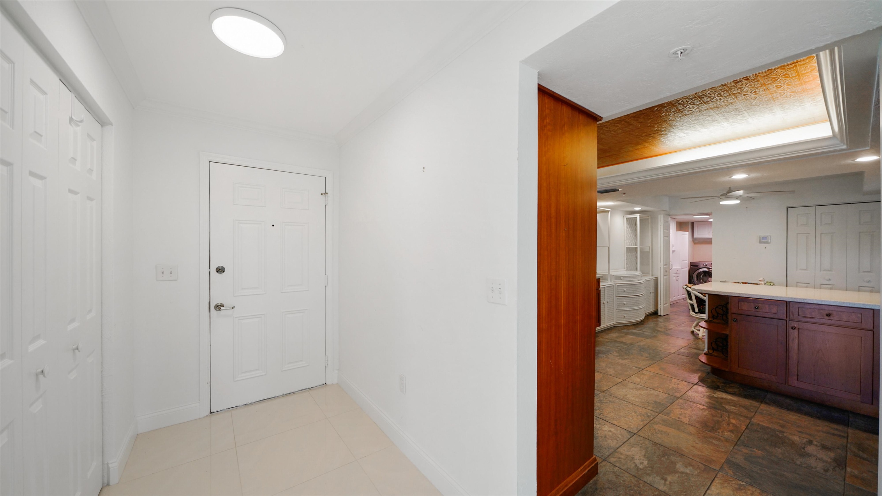 1 John Anderson Drive, Unit 218 Ormond Beach, FL 32176 - Photo 12 of 69 a view of a hallway and a dining room with furniture