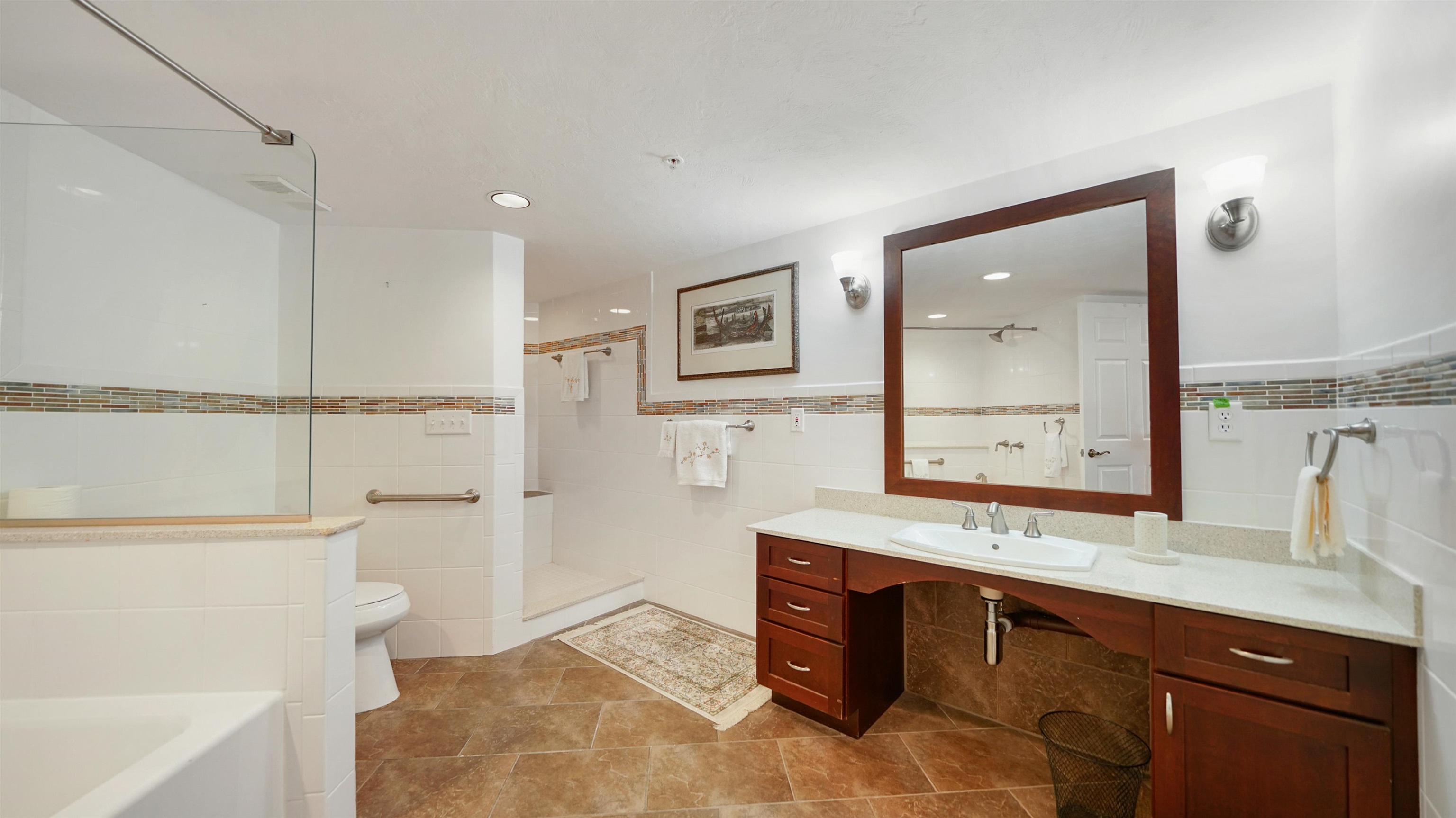 1 John Anderson Drive, Unit 218 Ormond Beach, FL 32176 - Photo 22 of 69 a spacious bathroom with a double vanity sink a toilet a mirror and shower