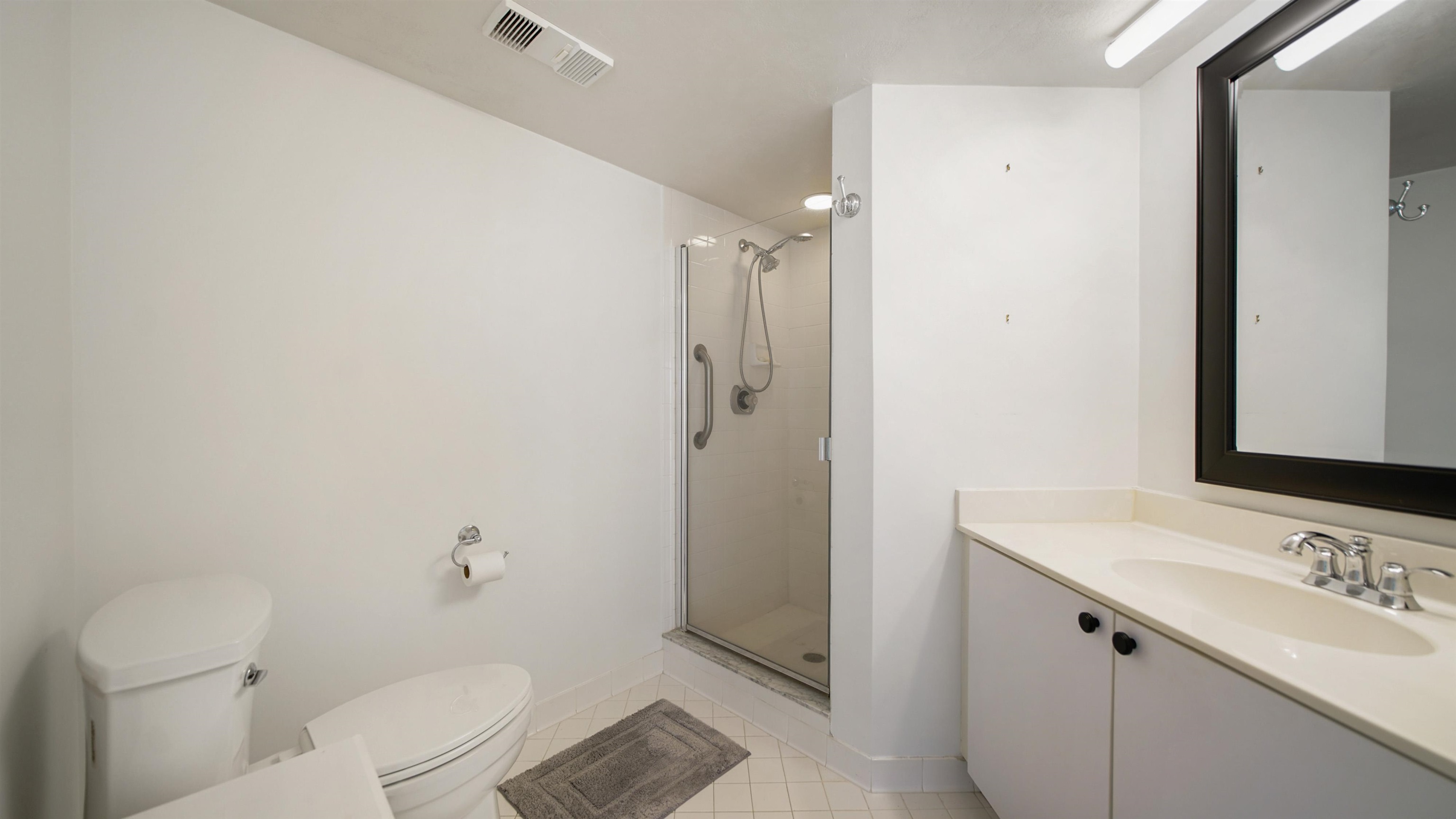 1 John Anderson Drive, Unit 218 Ormond Beach, FL 32176 - Photo 26 of 69 a bathroom with a sink a toilet and shower