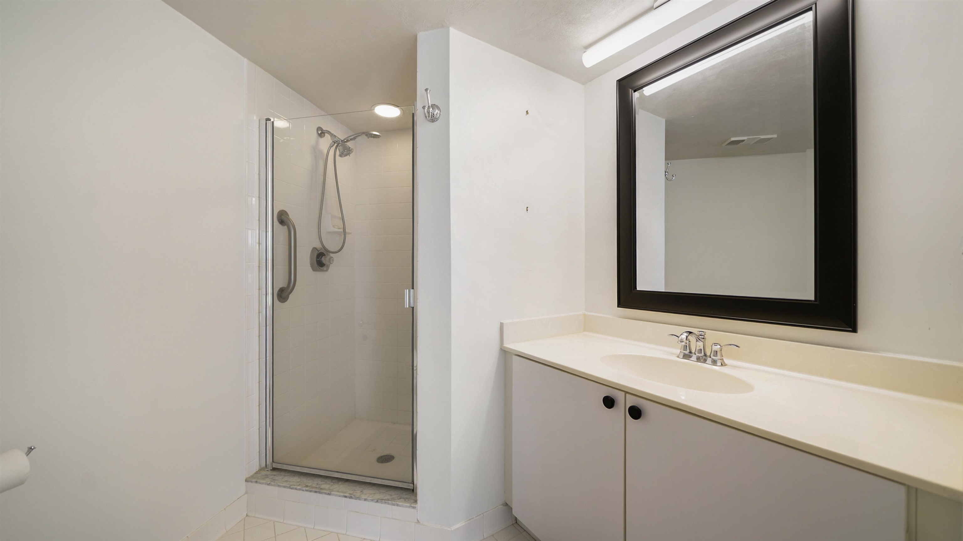 1 John Anderson Drive, Unit 218 Ormond Beach, FL 32176 - Photo 27 of 69 a bathroom with a shower sink and mirror