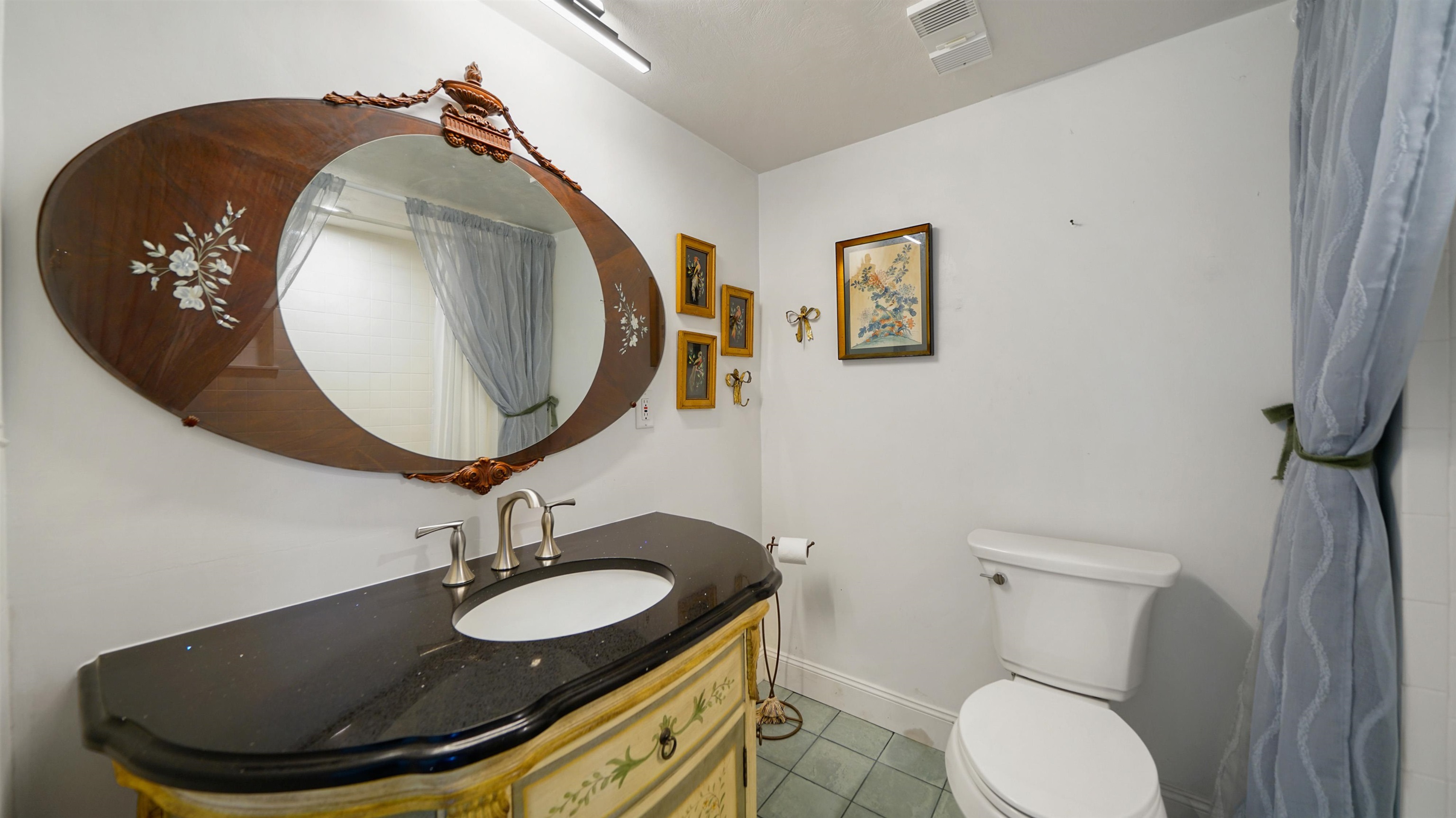 1 John Anderson Drive, Unit 218 Ormond Beach, FL 32176 - Photo 30 of 69 a bathroom with a toilet mirror and sink