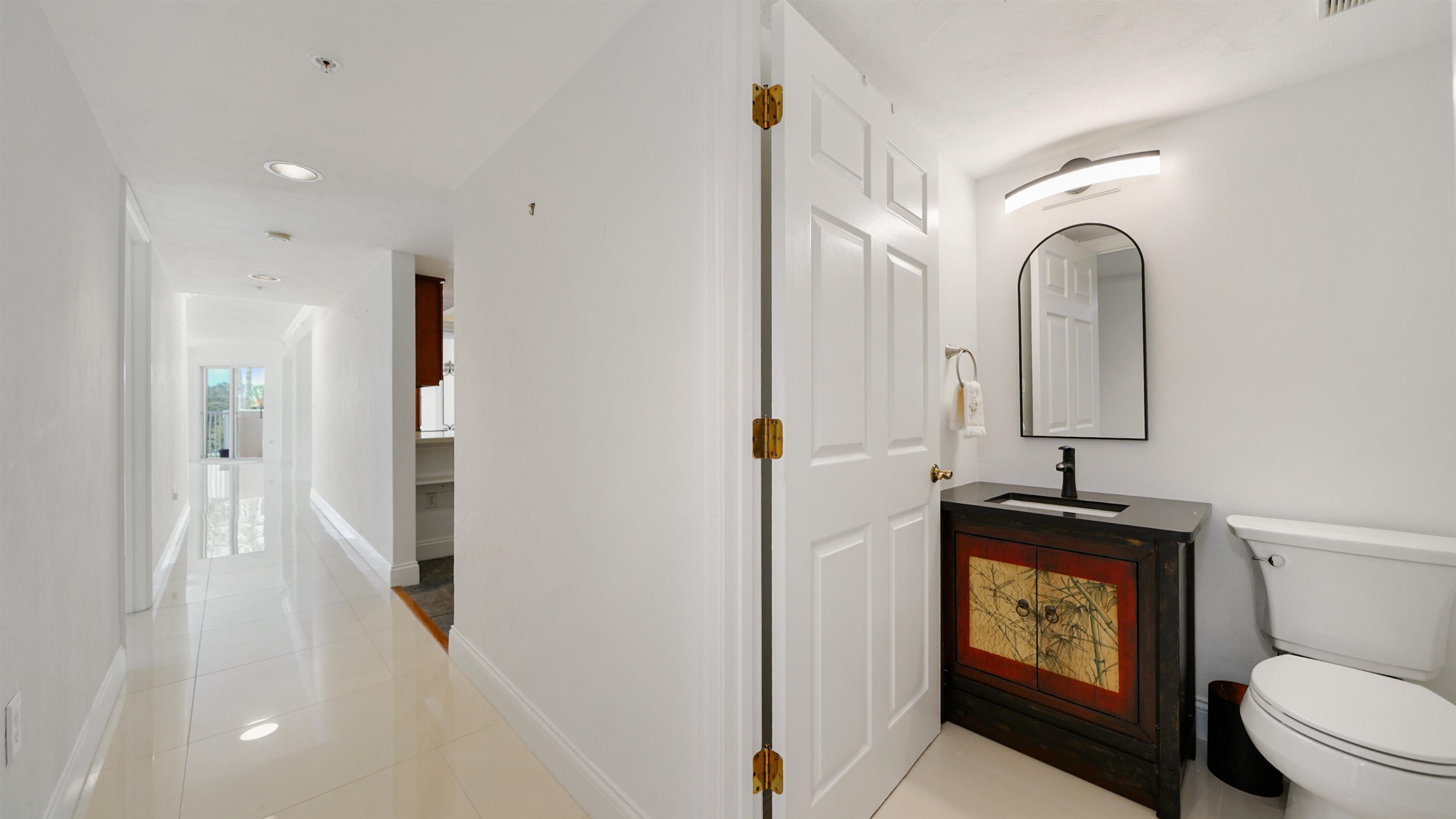 1 John Anderson Drive, Unit 218 Ormond Beach, FL 32176 - Photo 32 of 69 a bathroom with a toilet sink and mirror