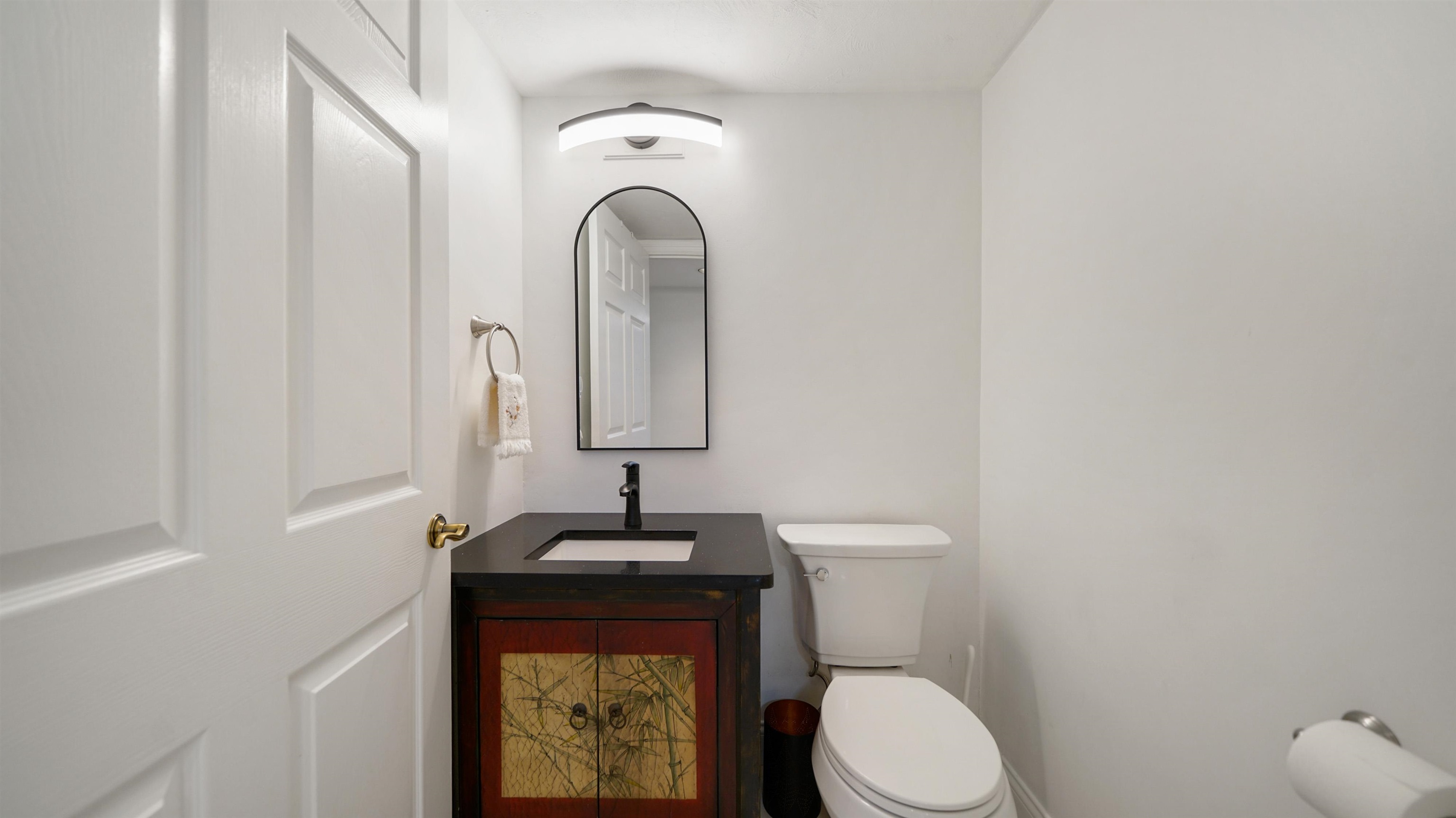 1 John Anderson Drive, Unit 218 Ormond Beach, FL 32176 - Photo 33 of 69 a bathroom with a toilet sink and mirror