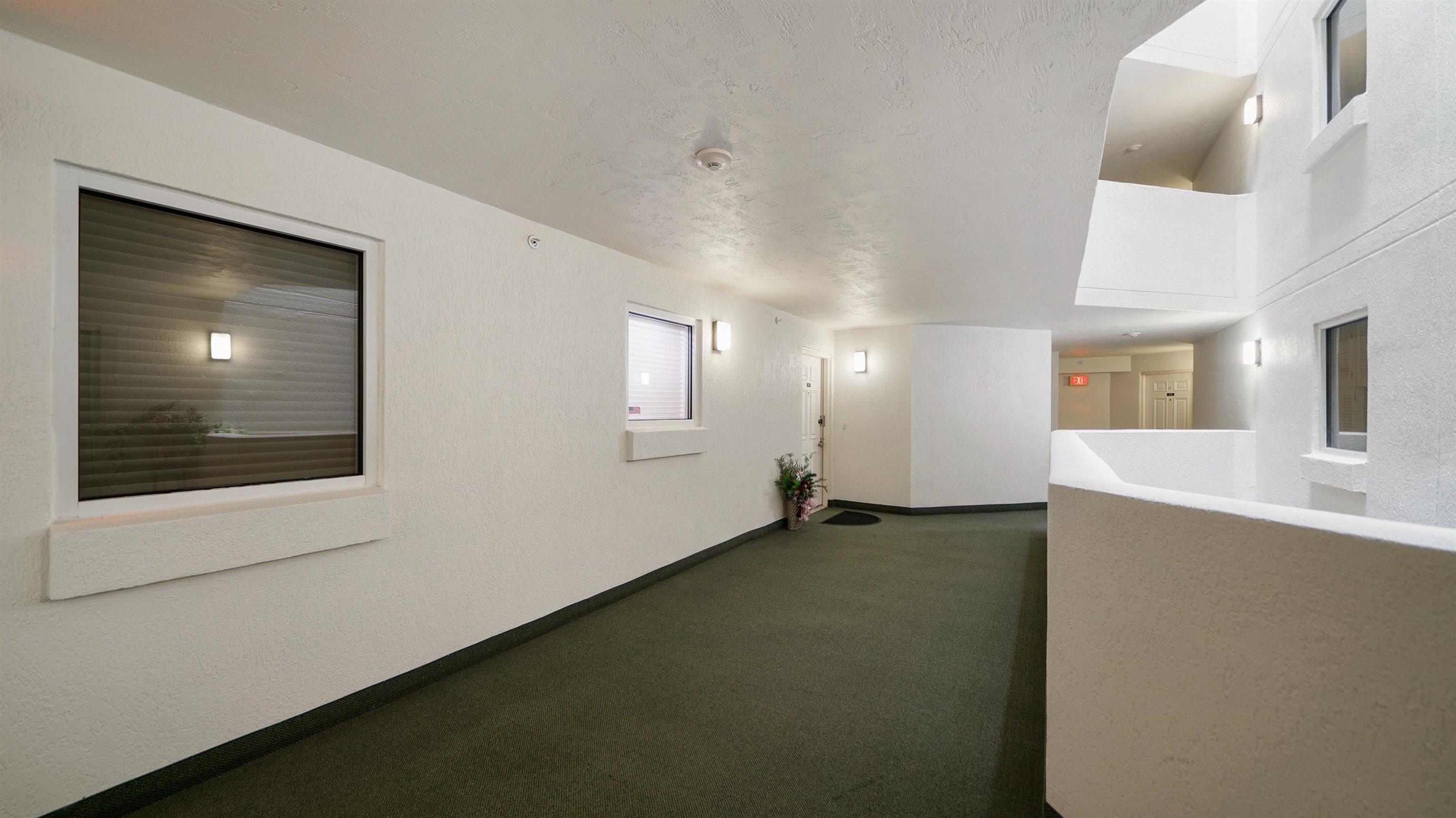 1 John Anderson Drive, Unit 218 Ormond Beach, FL 32176 - Photo 40 of 69 a view of an empty room with window and wooden floor