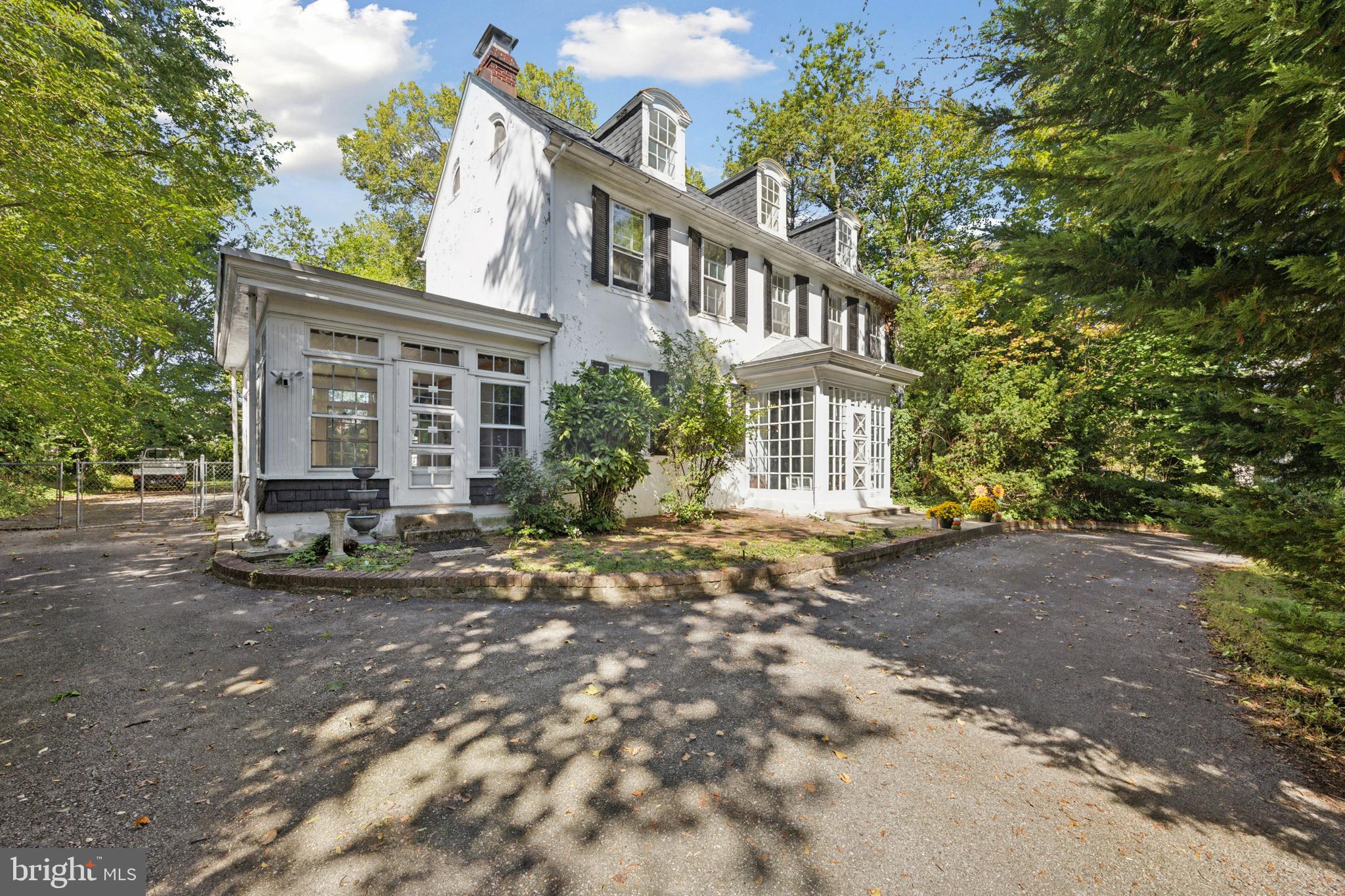 a view of a brick house with many windows next to a road