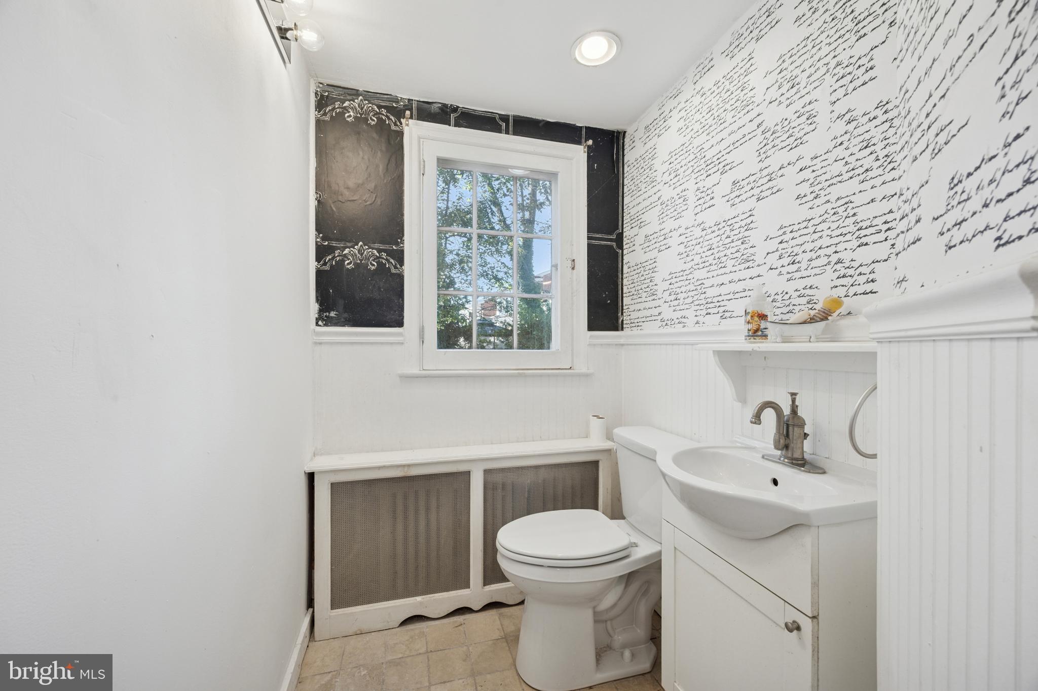 212 West 24th Street Chester, PA 19013 - Photo 13 of 30 a bathroom with a toilet a sink and mirror
