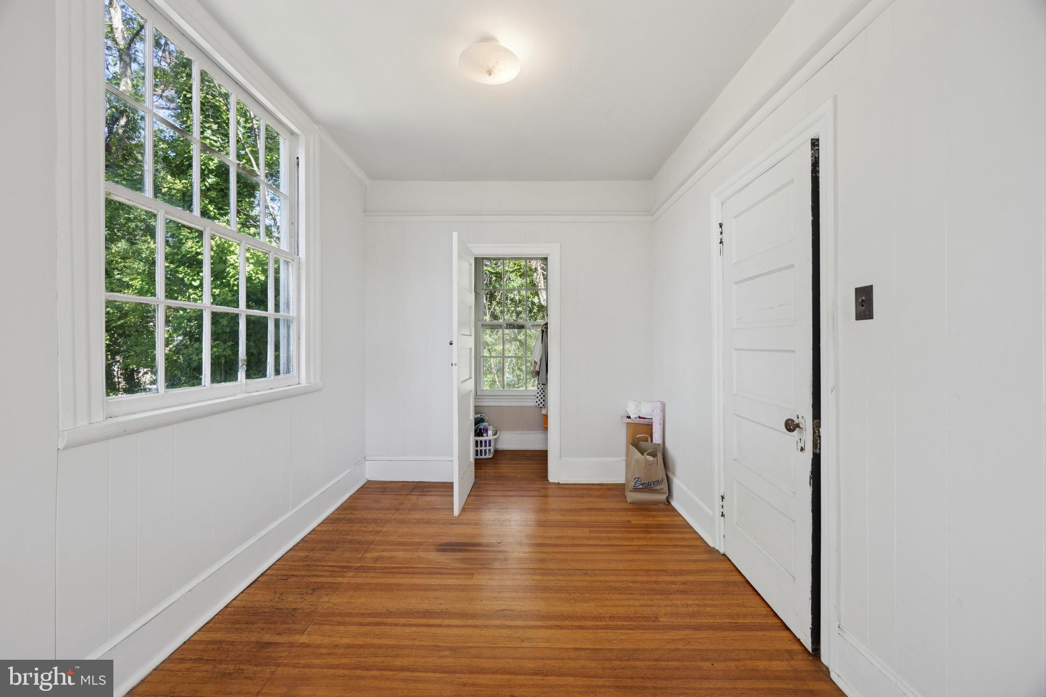 212 West 24th Street Chester, PA 19013 - Photo 22 of 30 a view of an empty room with wooden floor and a window