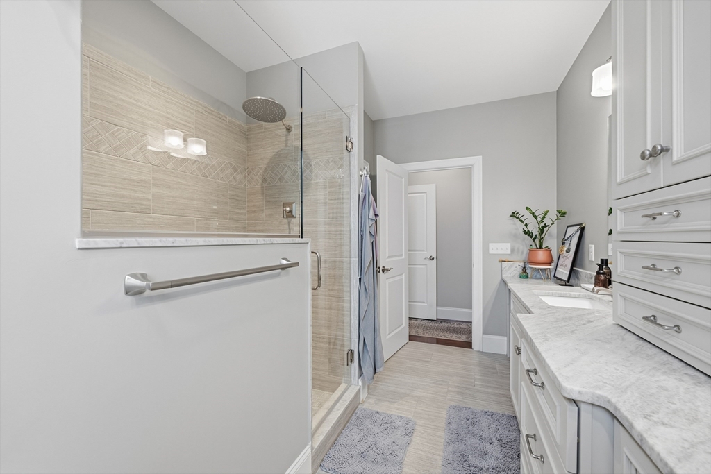 187 Rhode Island Road Lakeville, MA 02347 - Photo 26 of 42 a bathroom with a granite countertop sink a shower and a mirror