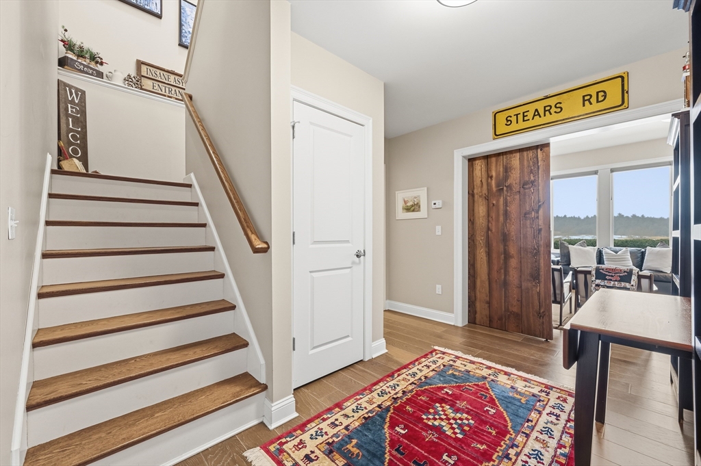 187 Rhode Island Road Lakeville, MA 02347 - Photo 28 of 42 a view of a hallway with wooden floor and windows