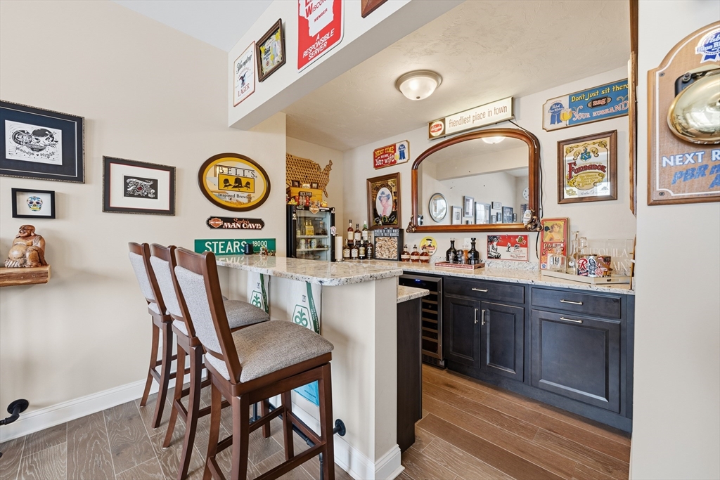 187 Rhode Island Road Lakeville, MA 02347 - Photo 32 of 42 a living room with granite countertop kitchen island a stove and a wooden floor