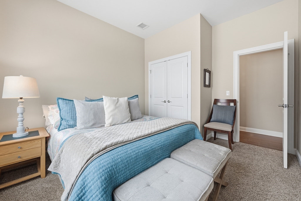 187 Rhode Island Road Lakeville, MA 02347 - Photo 36 of 42 a bedroom with a bed and a lamp