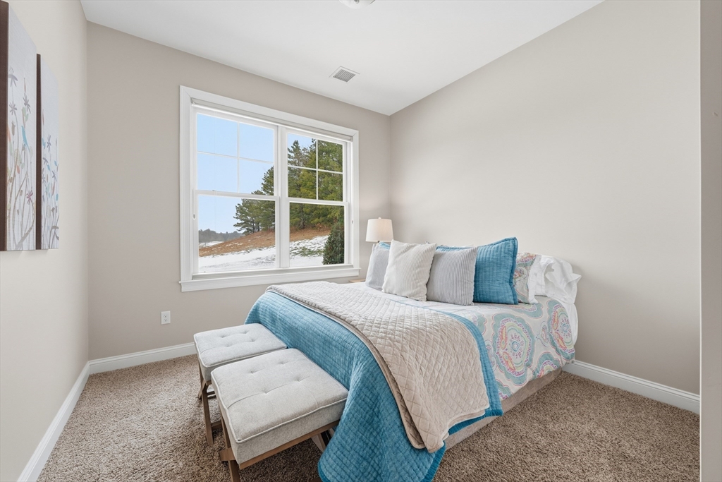 187 Rhode Island Road Lakeville, MA 02347 - Photo 37 of 42 a bedroom with a bed and a couch