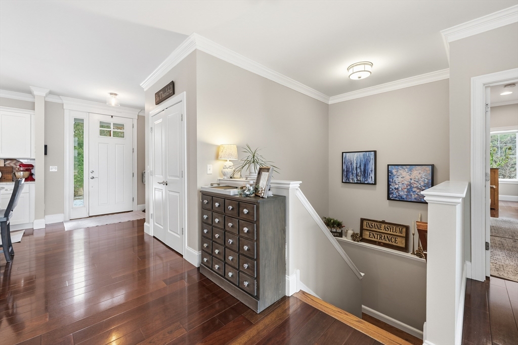 187 Rhode Island Road Lakeville, MA 02347 - Photo 4 of 42 a hallway with wooden floor and stairs