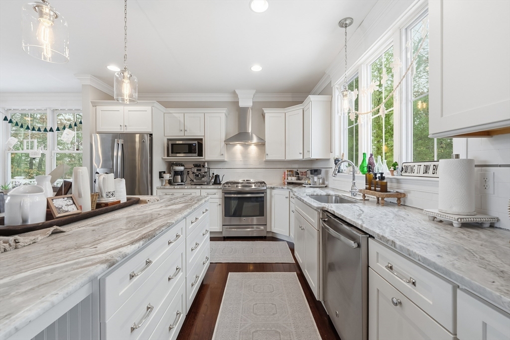 187 Rhode Island Road Lakeville, MA 02347 - Photo 7 of 42 a large kitchen with granite countertop a large window and stainless steel appliances