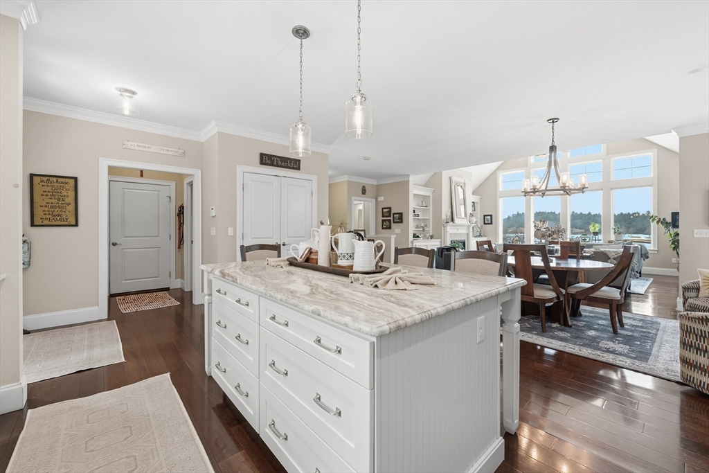 187 Rhode Island Road Lakeville, MA 02347 - Photo 10 of 42 a room with kitchen island a sink and a chandelier
