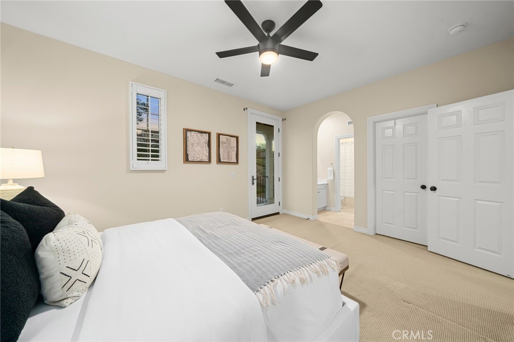 46 Silhouette Irvine, CA 92603 - Photo 34 of 42 a spacious bedroom with a bed and a chandelier