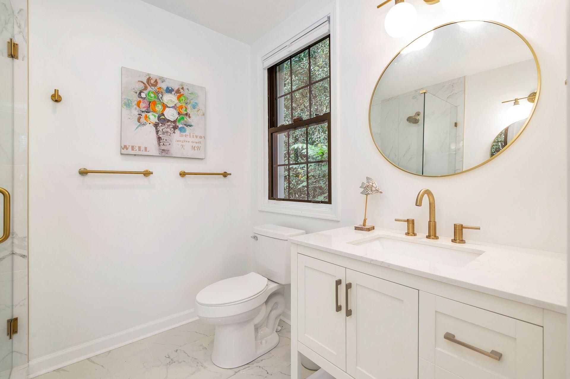 240 Almeria Road West Palm Beach, FL 33405 - Photo 13 of 24 a bathroom with a toilet a sink and a mirror
