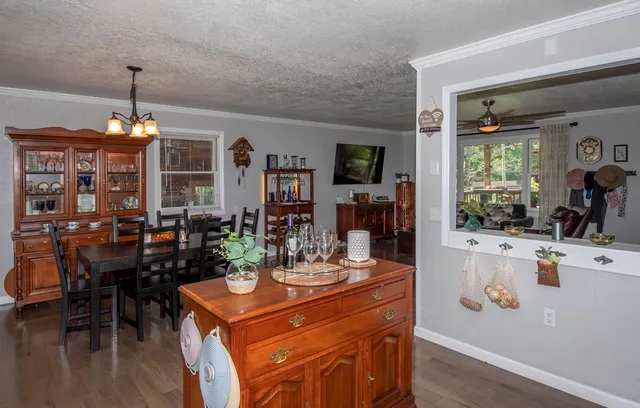 a view of a dining room with furniture and chandelier