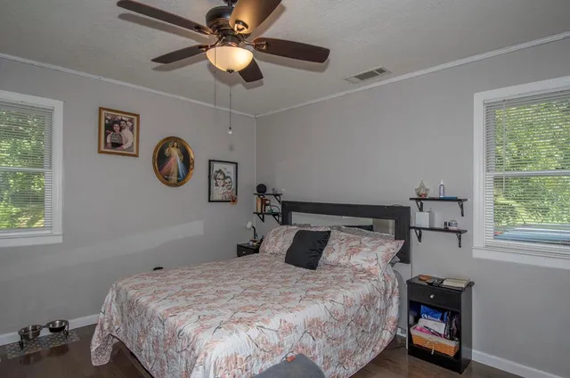 a bedroom with a bed and a window