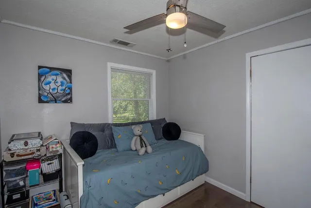 a bedroom with a bed and a window