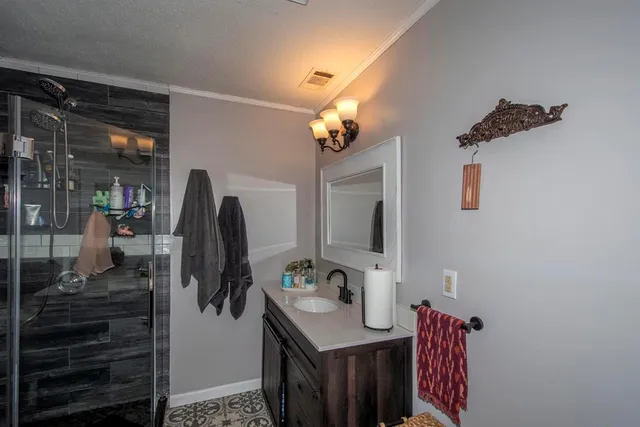 a bathroom with a sink vanity and a mirror