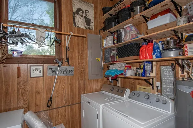 a utility room with dryer washer and a rug