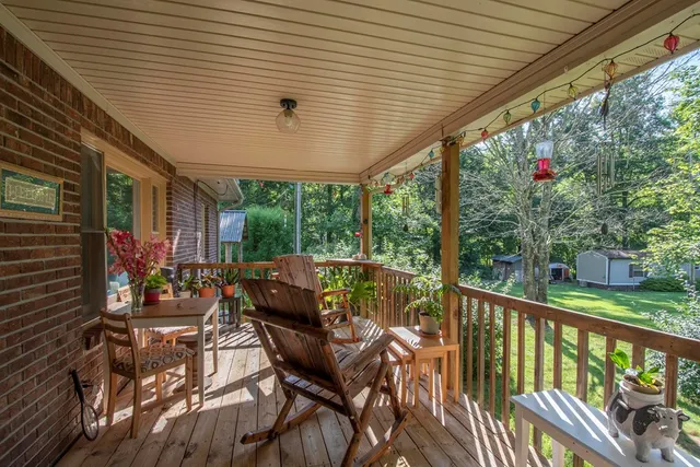 a view of a patio with table and chairs and wooden floor