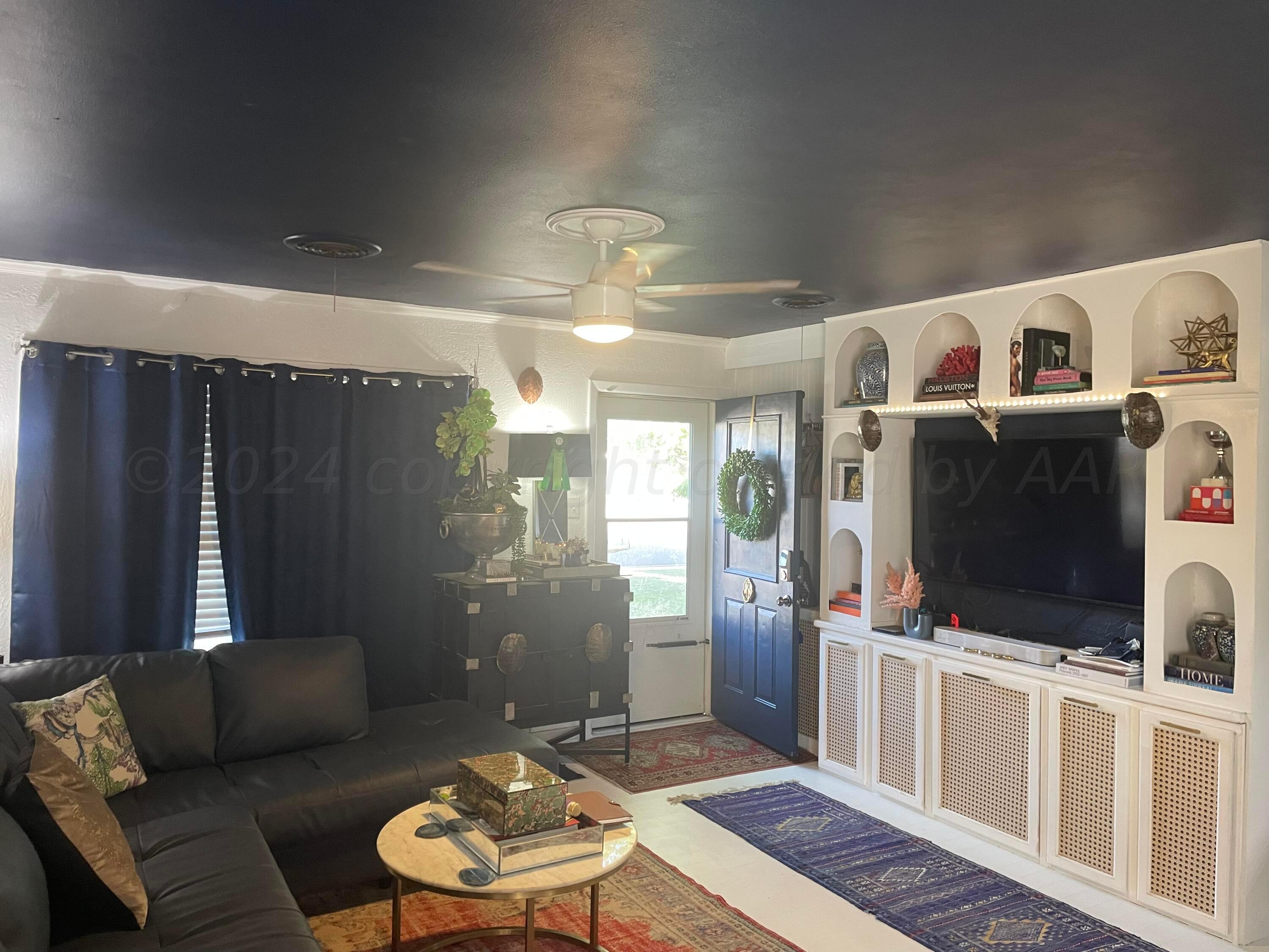 5010 South Fannin Street Amarillo, TX 79110 - Photo 2 of 10 a living room with furniture and a flat screen tv