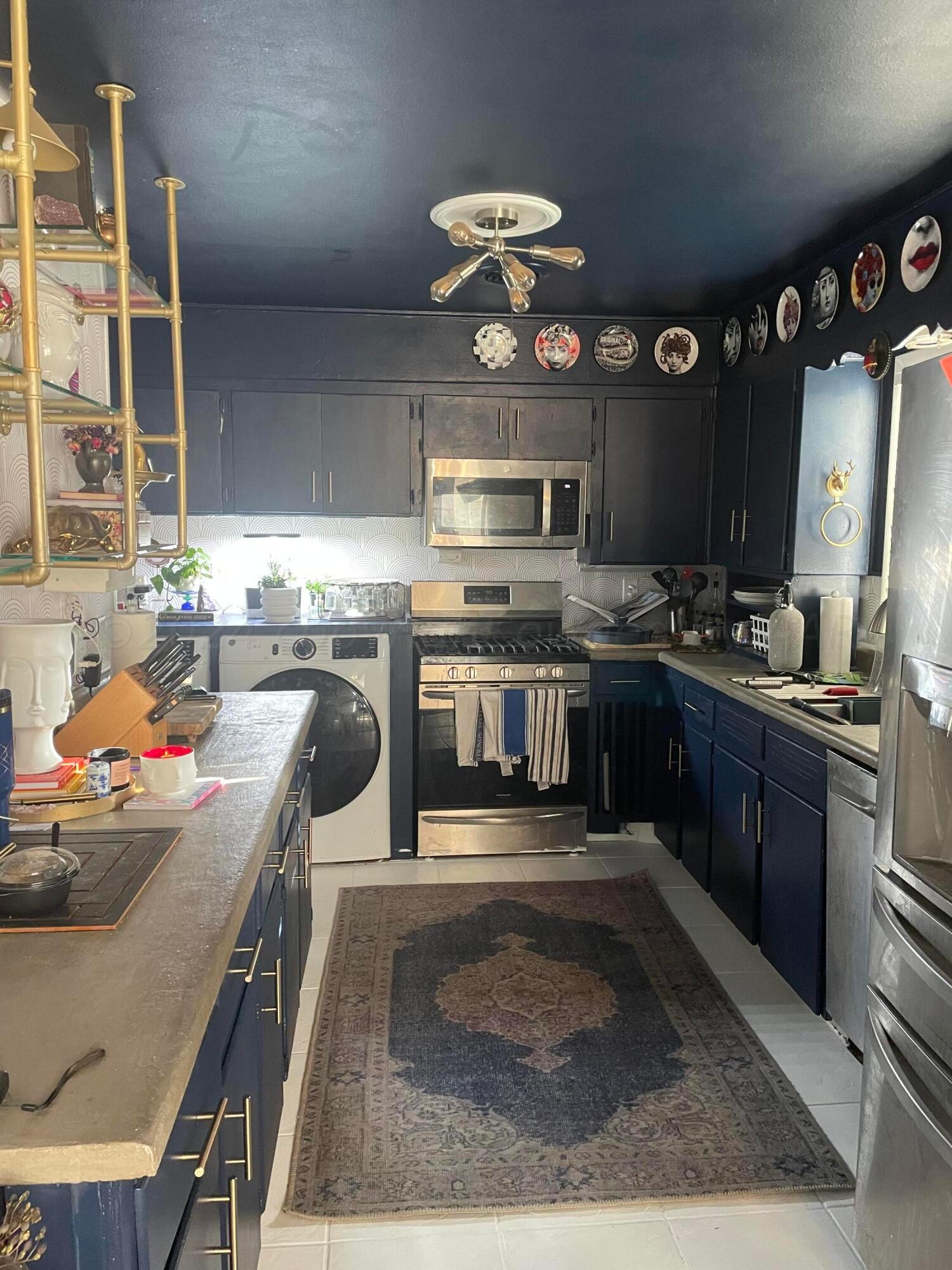 5010 South Fannin Street Amarillo, TX 79110 - Photo 5 of 10 a kitchen with stainless steel appliances granite countertop a stove a sink and a microwave