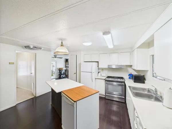 a kitchen with a sink a stove and refrigerator