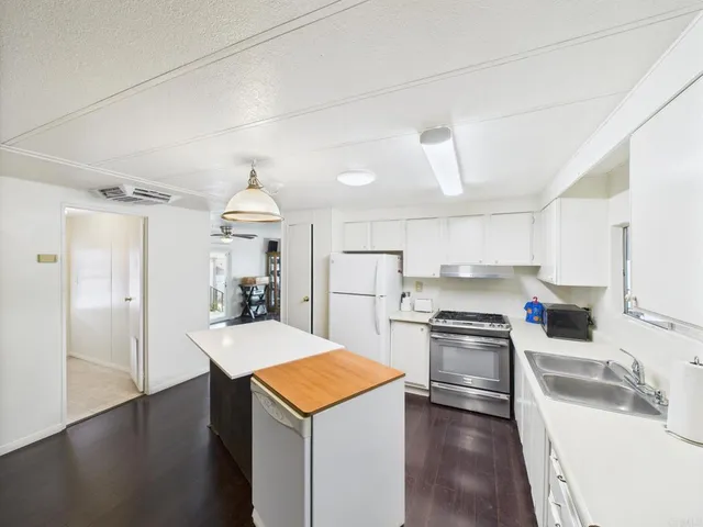 a kitchen with a sink a stove and refrigerator