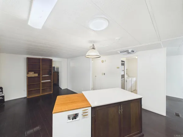 a kitchen with sink cabinets and wooden floor