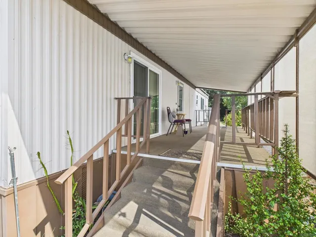 a very nice looking room with a large window and furniture