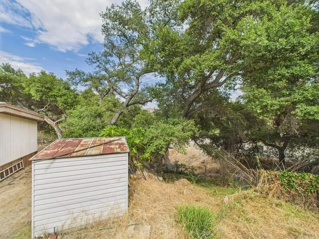 a view of a backyard with sitting area