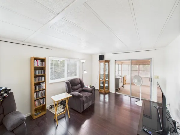 a living room with furniture and a floor to ceiling window