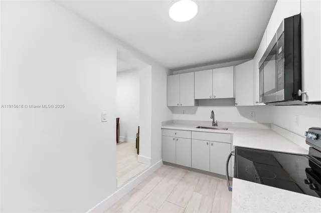 a kitchen with a sink and cabinets