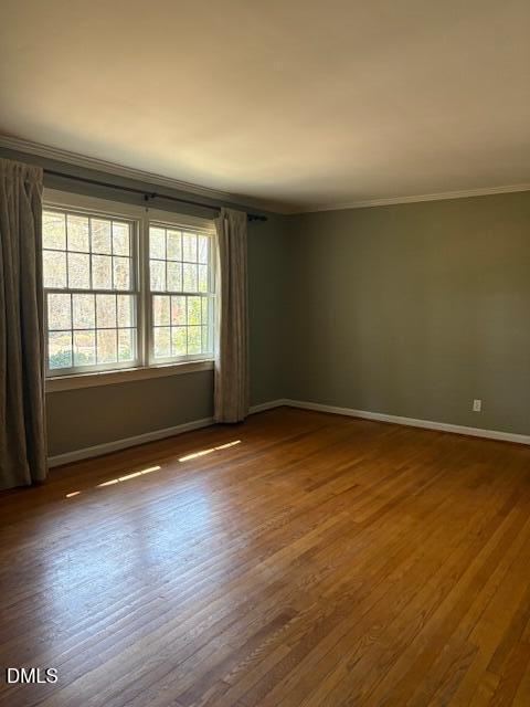 4408 Boxwood Road Raleigh, NC 27612 - Photo 2 of 7 an empty room with wooden floor and windows