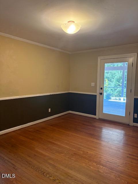 4408 Boxwood Road Raleigh, NC 27612 - Photo 4 of 7 an empty room with wooden floor and windows
