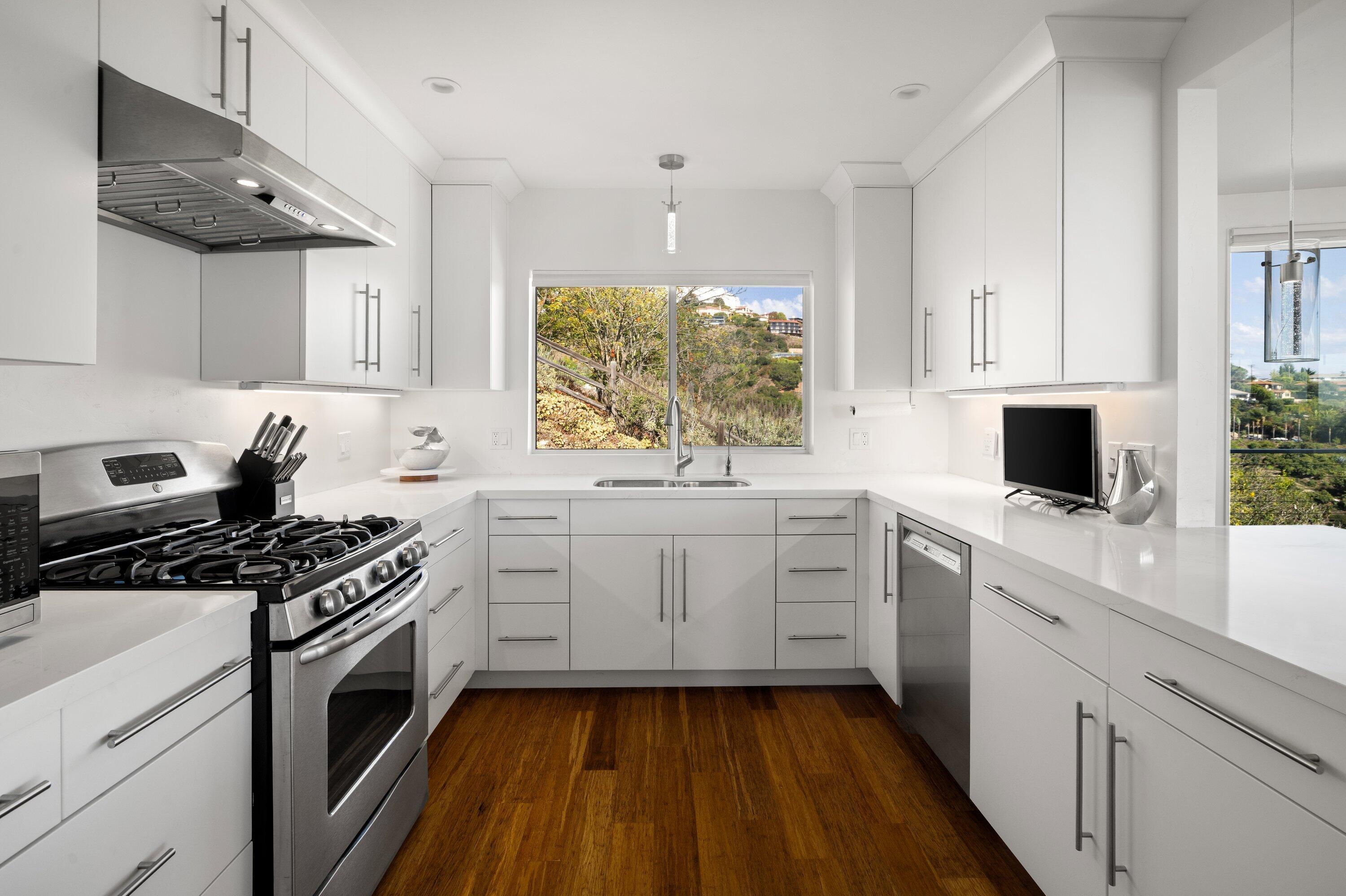 128 Las Alturas Road Santa Barbara, CA 93103 - Photo 11 of 34 a kitchen with white cabinets appliances and a window