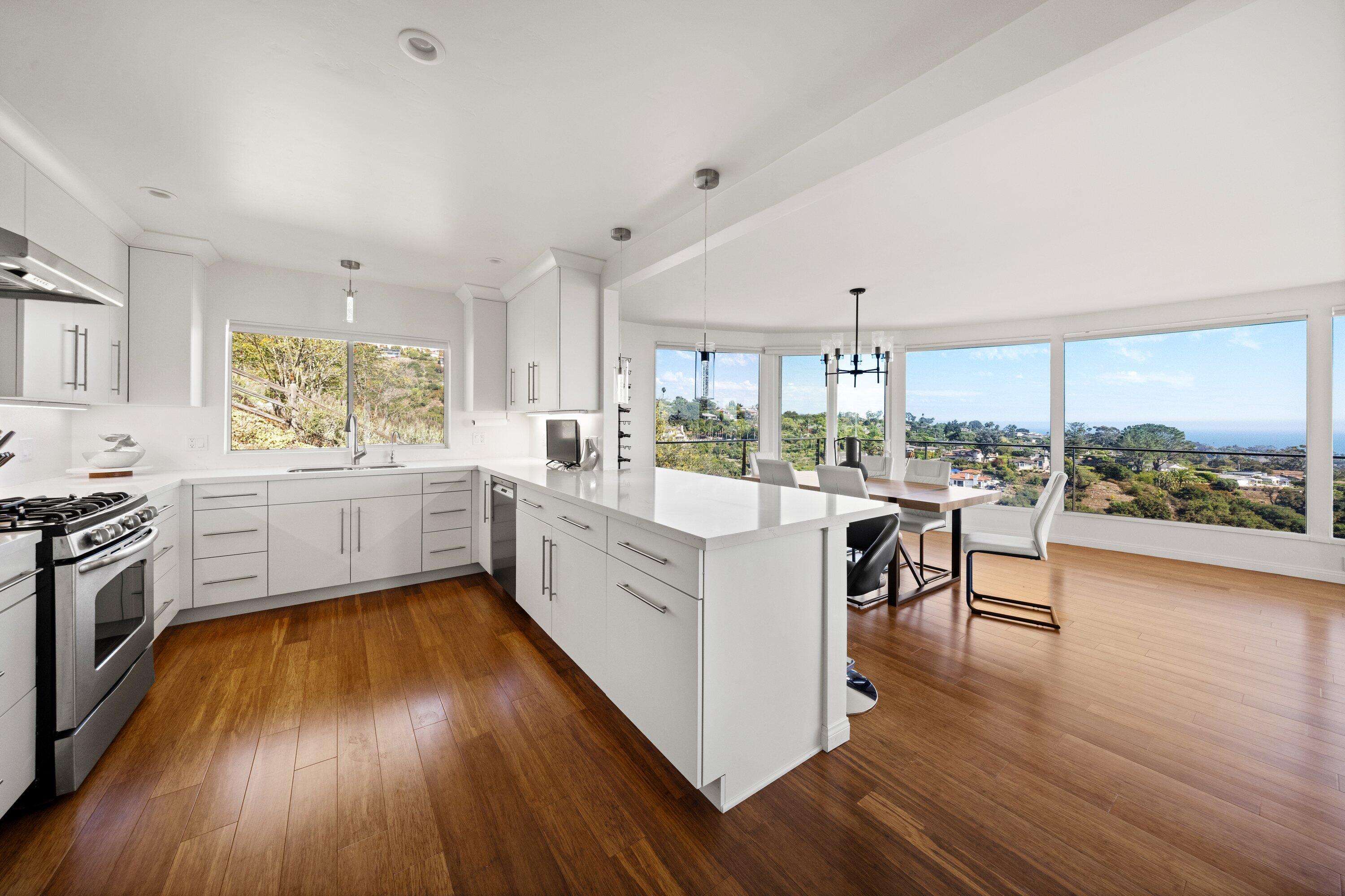 128 Las Alturas Road Santa Barbara, CA 93103 - Photo 13 of 34 a kitchen with a sink a counter top space stainless steel appliances and windows