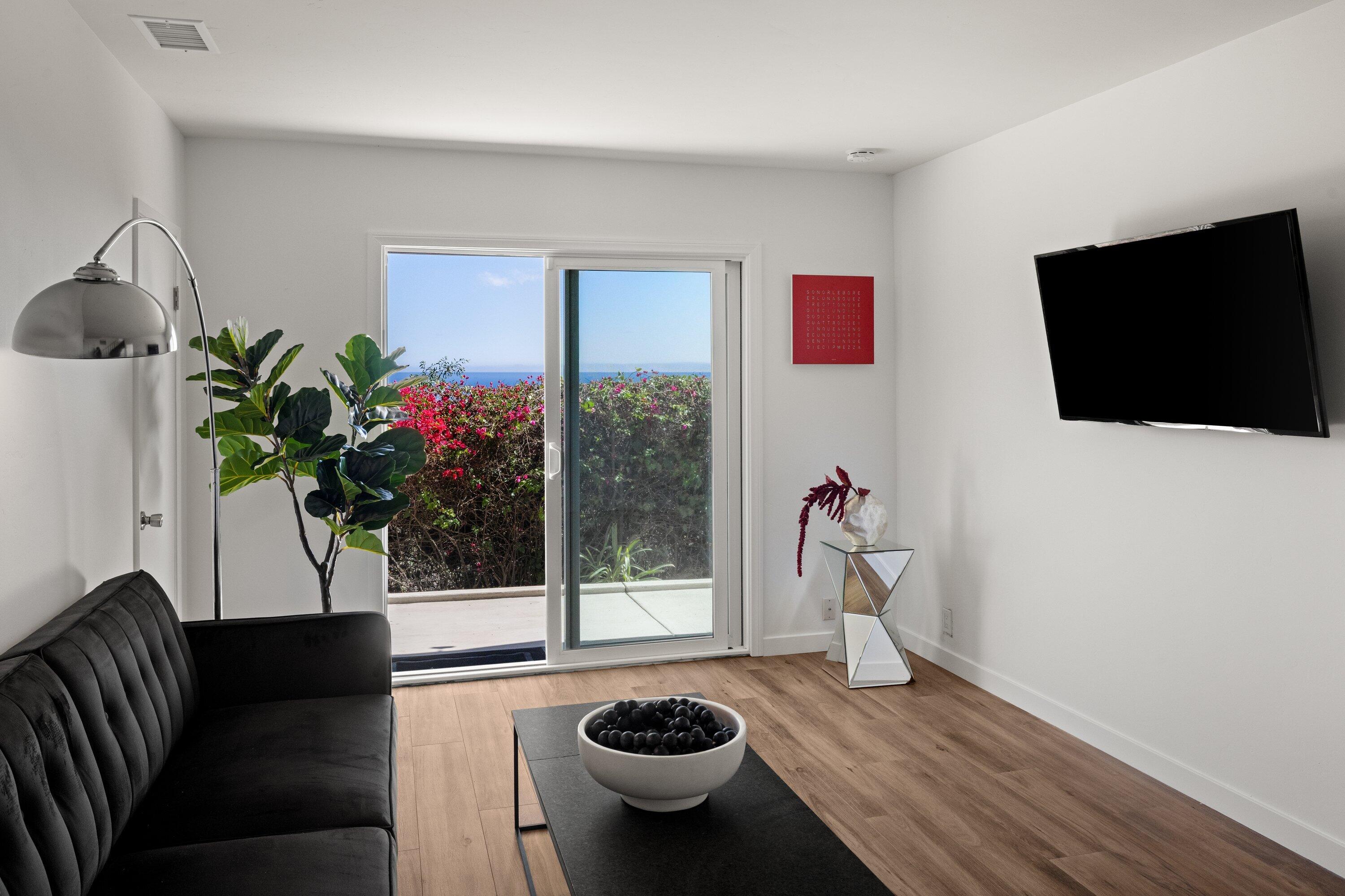 128 Las Alturas Road Santa Barbara, CA 93103 - Photo 18 of 34 a living room with furniture and a flat screen tv