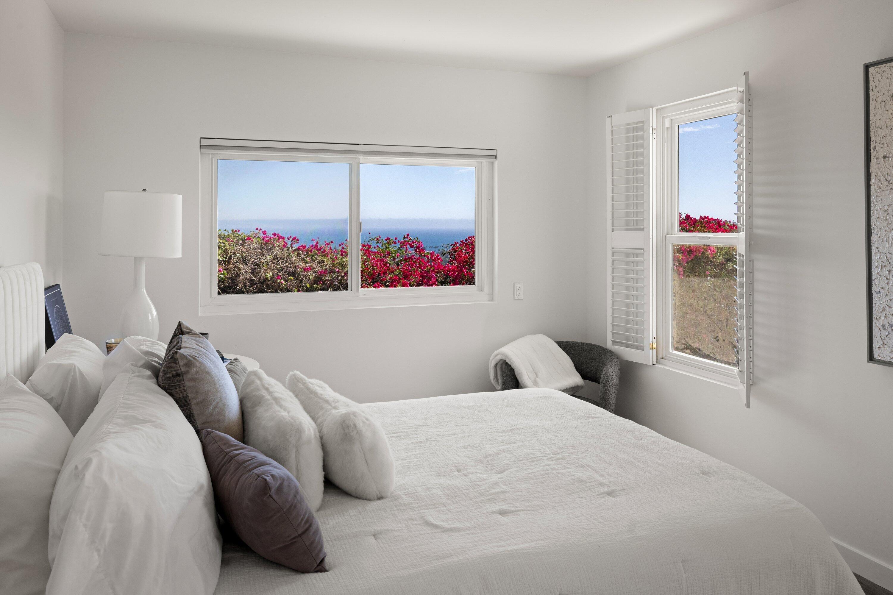 128 Las Alturas Road Santa Barbara, CA 93103 - Photo 22 of 34 a bedroom with a bed and a painting on the wall