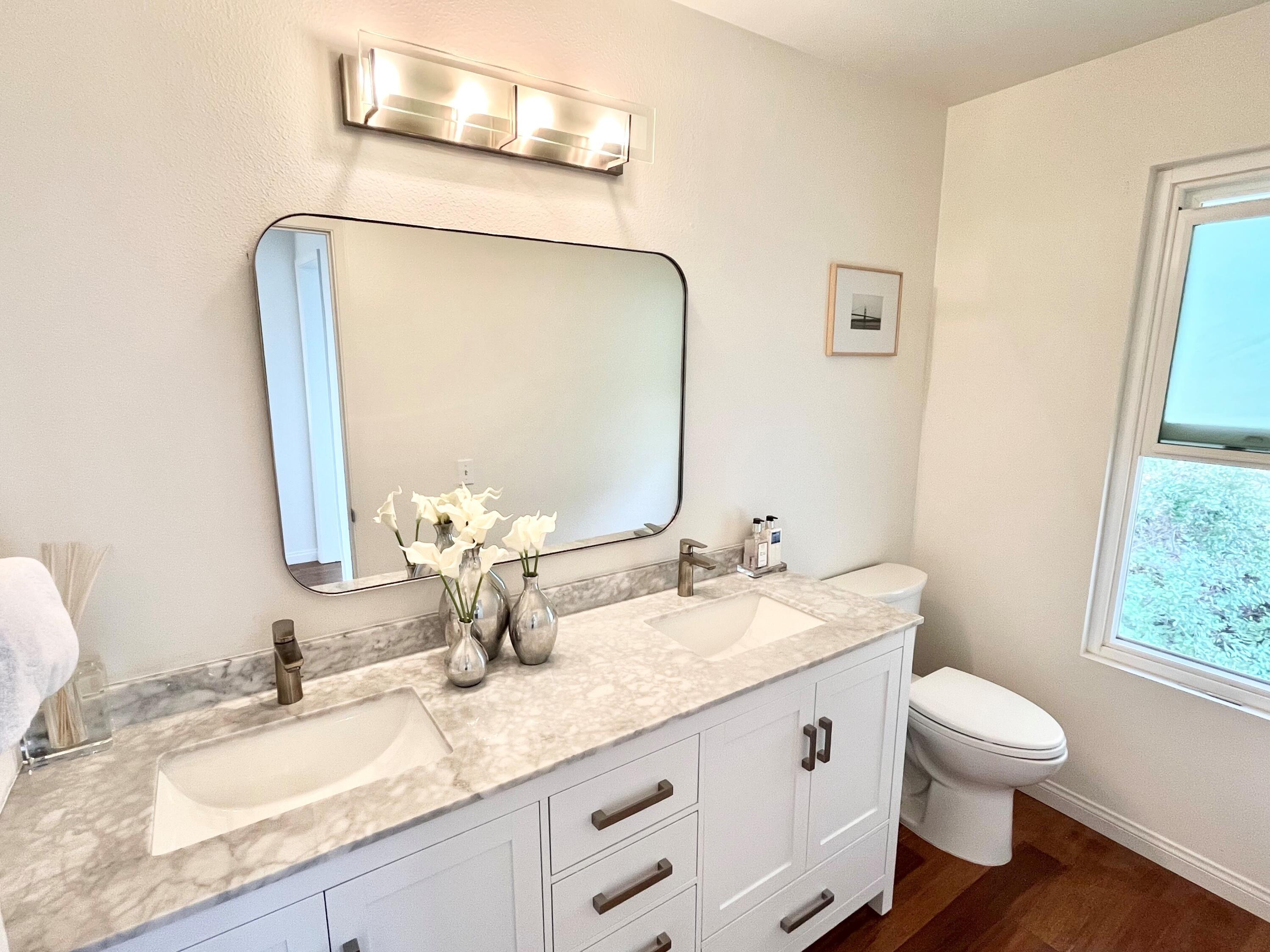 128 Las Alturas Road Santa Barbara, CA 93103 - Photo 28 of 34 a bathroom with a granite countertop toilet sink and mirror