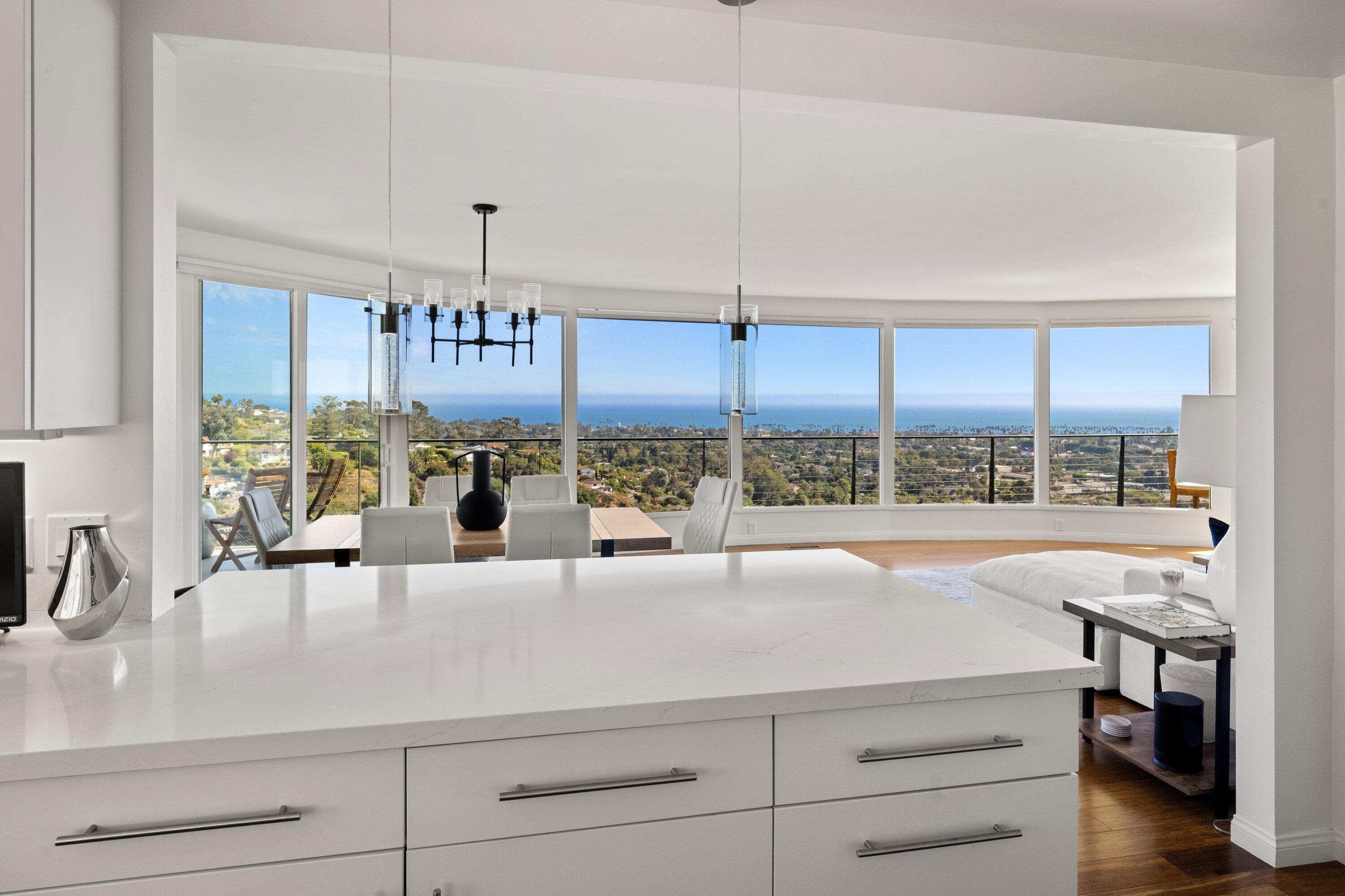 128 Las Alturas Road Santa Barbara, CA 93103 - Photo 5 of 34 a view of a kitchen with kitchen island a large window cabinets and stainless steel appliances