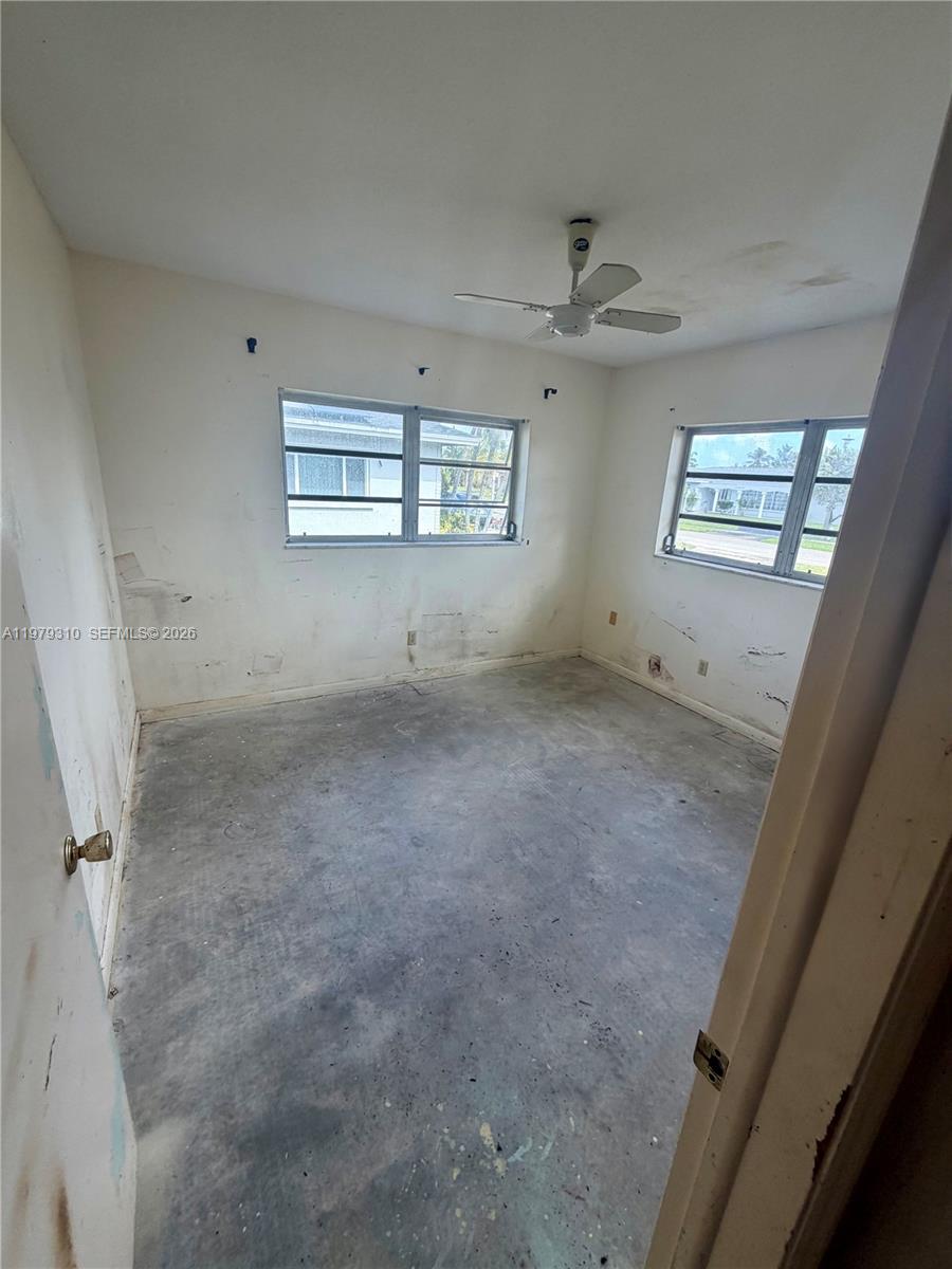 1761 Southwest 55th Avenue Plantation, FL 33317 - Photo 16 of 18 an empty room with a ceiling fan and window